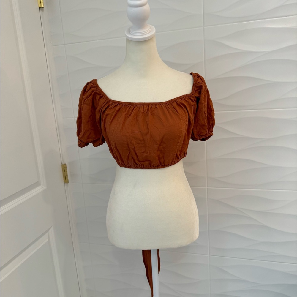 Brown crop top with wrap around detail. Size small. New.